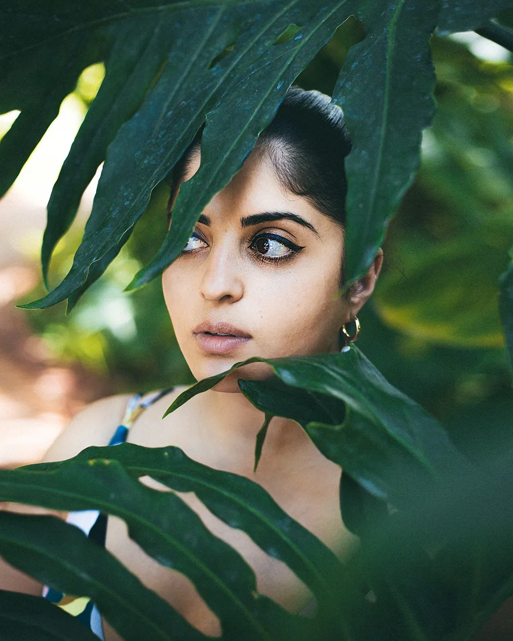 Portrait of Juhi among palm leaves