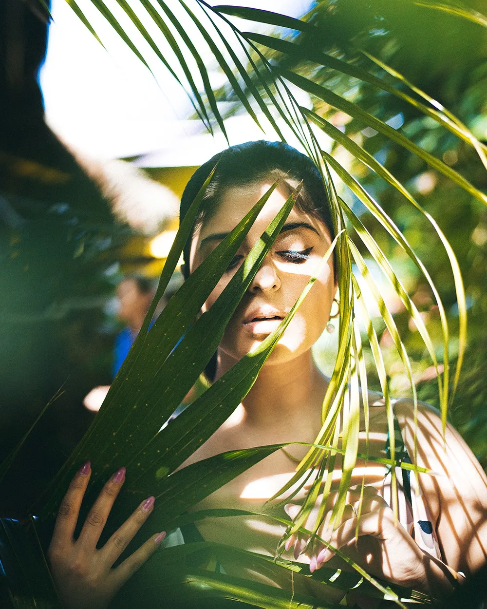 Portrait of Juhi Sharma among palm leaves